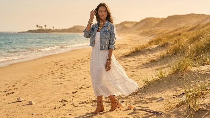 Woman wearing a boho fall midi dress styled with cozy autumn layers and boots