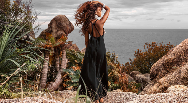 Model wearing a flowy boho dress with vibrant patterns, perfect for beach outings and summer adventures. Boho Beach Hut