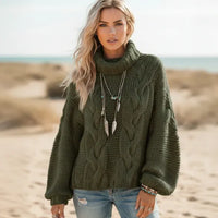 Woman wearing army green boho chunky knit turtleneck sweater with wide sleeves