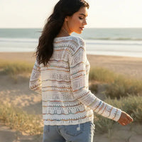 Back of woman wearing striped boho open knit V neck sweater with long sleeves