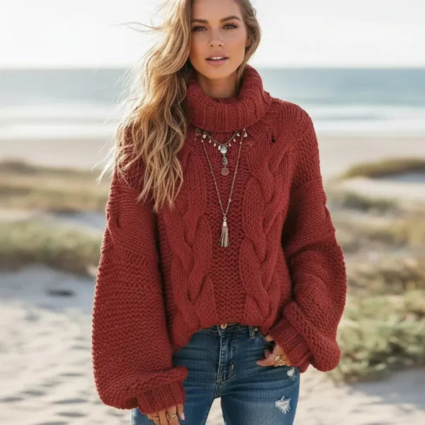 Woman wearing brick red boho chunky knit turtleneck sweater with wide sleeves