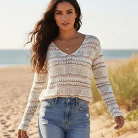 Woman wearing striped boho open knit V neck sweater with long sleeves