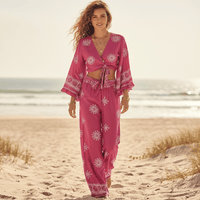 Woman wearing a boho fuchsia print kimono and wide leg pants set with a tie-front top, bell sleeves, relaxed fit, and lightweight bohemian resort style.