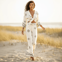 Woman wearing a boho off white print kimono and wide leg pants set with a tie-front top, lightweight fabric, and relaxed bohemian style.