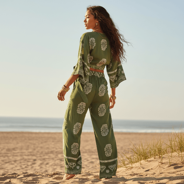 Back view of a boho olive green print kimono and wide leg pants set featuring a flowy silhouette, wide leg pants, and lightweight bohemian design.