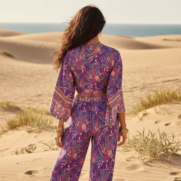 Back view of a boho purple floral kimono and wide leg pants set featuring a flowing fit, floral print, and wide leg pants.