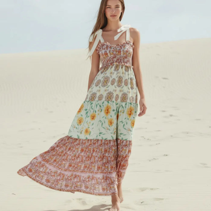 Pink boho floral maxi dress with ribbon tie straps, stretch bodice and colorful tiered patchwork skirt