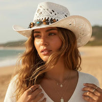 White beaded straw cowgirl hat with turquoise-colored beads and boho western woven cowboy design