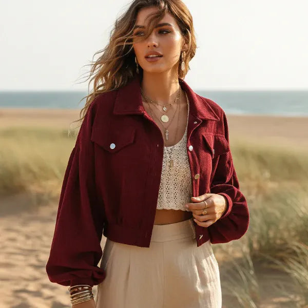 Woman wearing a burgundy boho cropped corduroy jacket with lantern sleeves and button front