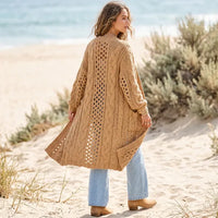 Women’s camel brown long knit cardigan with pockets, open-front design, and chunky boho knit detailing.