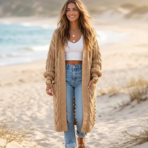 Camel brown boho oversized long knit cardigan with chunky textured stitching, balloon sleeves, and front pockets styled with jeans.