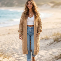 Camel brown boho oversized long knit cardigan with chunky textured stitching, balloon sleeves, and front pockets styled with jeans.