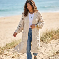 Cream chunky knit cardigan sweater for women featuring an oversized fit, open front, and long bohemian silhouette.