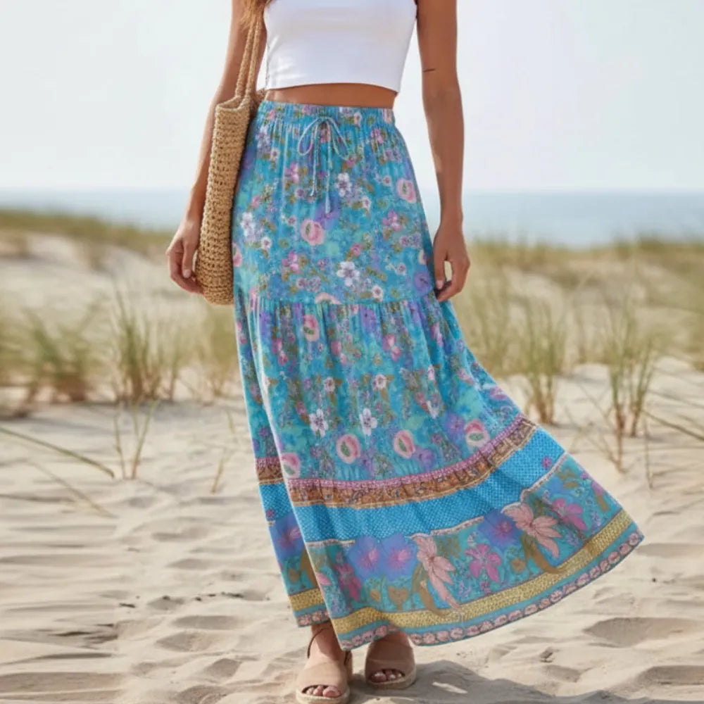Woman wearing cornflower blue floral maxi skirt with high drawstring waist and ruffle hem