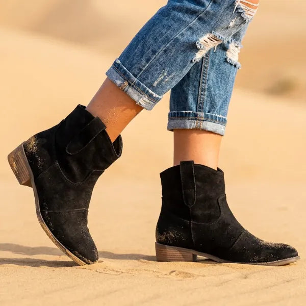 Black western ankle boots for women featuring slouchy shafts, low block heels, and a casual cowboy-inspired design.