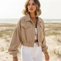 Woman wearing a khaki boho cropped corduroy jacket with lantern sleeves and button front