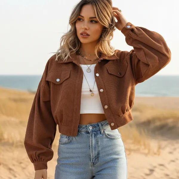 Woman wearing a rust brown boho cropped corduroy jacket with lantern sleeves and button front