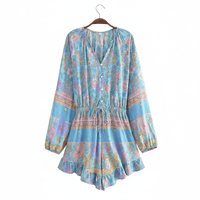 Blue floral boho romper with long balloon sleeves, V-neck button front, tassel drawstring waist, and ruffled shorts.