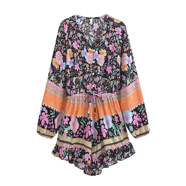 Black floral boho romper with long balloon sleeves, V-neck button front, tassel drawstring waist, colorful floral print, and ruffled shorts.