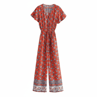 Red Crimson Bloom boho floral wide leg jumpsuit with pockets featuring a rayon cotton blend, V-neckline, short flutter sleeves, adjustable drawstring waist, front button detail, and wide-leg pants.