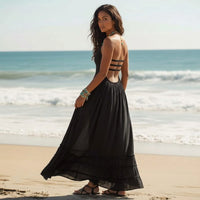 Back of a black backless halter maxi dress with long flowy tiered skirt