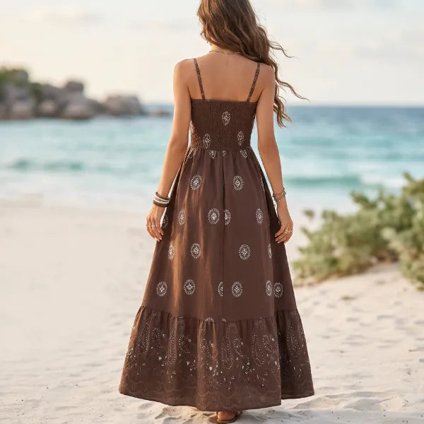 Women’s brown spaghetti strap maxi dress with paisley print, fitted waist, and tiered ruffle skirt.