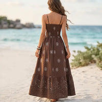 Women’s brown spaghetti strap maxi dress with paisley print, fitted waist, and tiered ruffle skirt.
