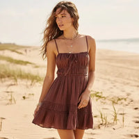 Woman wearing coffee brown boho backless tiered mini dress with tie straps