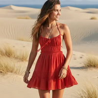 Woman wearing red boho backless tiered mini dress with tie straps