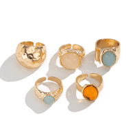 Close-up of adjustable vintage gold-tone statement rings with hammered finishes and decorative oval and round accents.