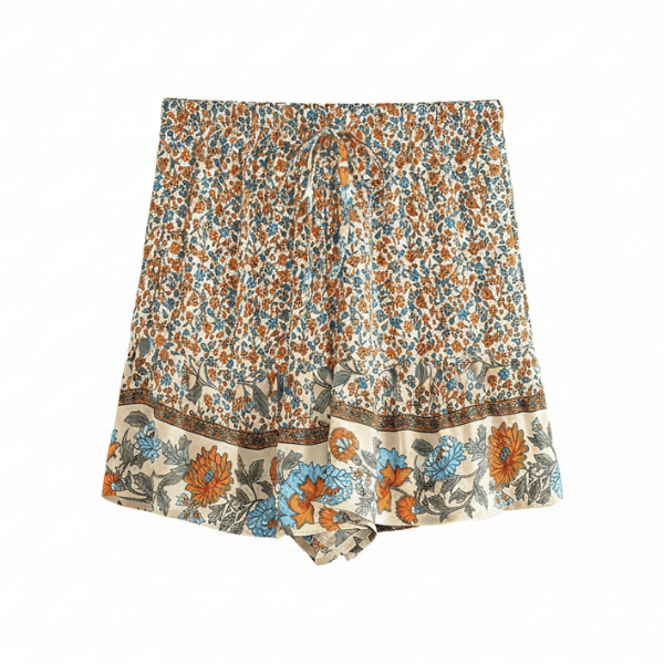 Coastal Wildflower boho floral shorts with functional side pockets, a high waist drawstring waistband, lightweight rayon fabric, and a relaxed flowy fit with a vintage-inspired floral border.