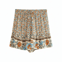 Coastal Wildflower boho floral shorts with functional side pockets, a high waist drawstring waistband, lightweight rayon fabric, and a relaxed flowy fit with a vintage-inspired floral border.