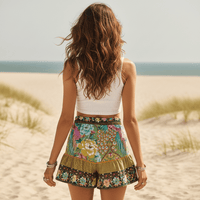 Back of green boho floral high waist drawstring shorts with pockets in breathable cotton rayon featuring a colorful peacock-inspired print for summer vacation and beach outfits.