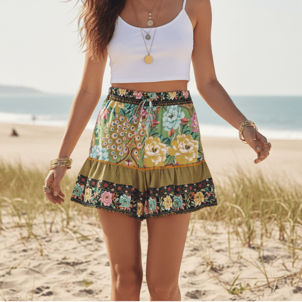 Green boho floral high waist drawstring shorts with pockets in breathable cotton rayon featuring a colorful peacock-inspired print for summer vacation and beach outfits.
