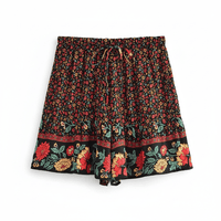 Midnight Meadow black boho floral drawstring shorts with a high-rise elastic waist and colorful floral border.