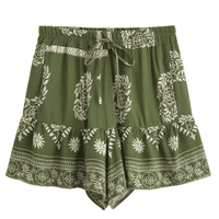 Olive Grove green boho floral high waist drawstring shorts with pockets in breathable cotton rayon featuring a botanical print and ruffle hem for summer vacations, beach days, and casual bohemian outfits.