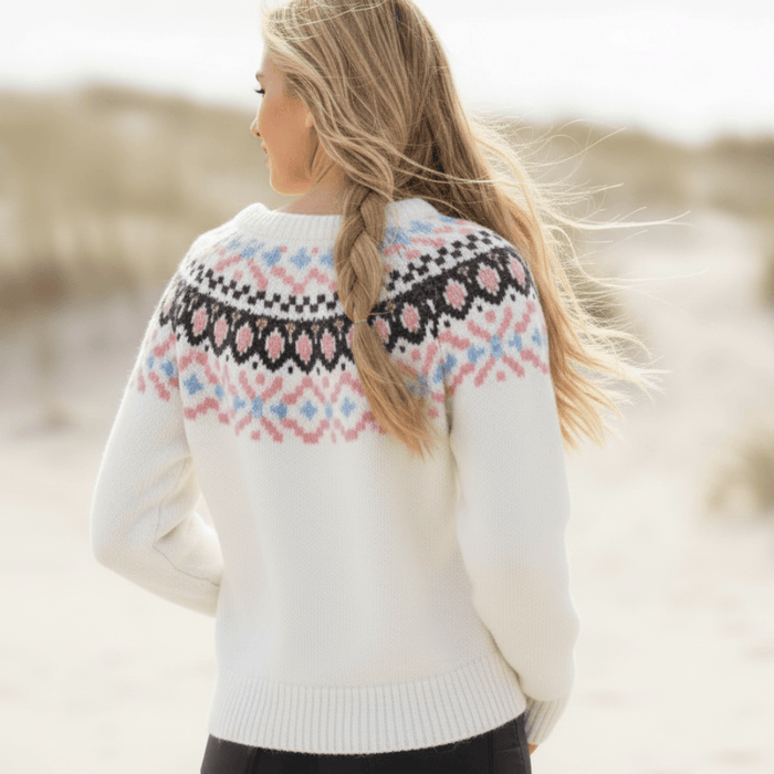 Woman wearing an off-white boho vintage knit pullover sweater with brown and pink geometric yoke, O-neck, long sleeves and ribbed trim