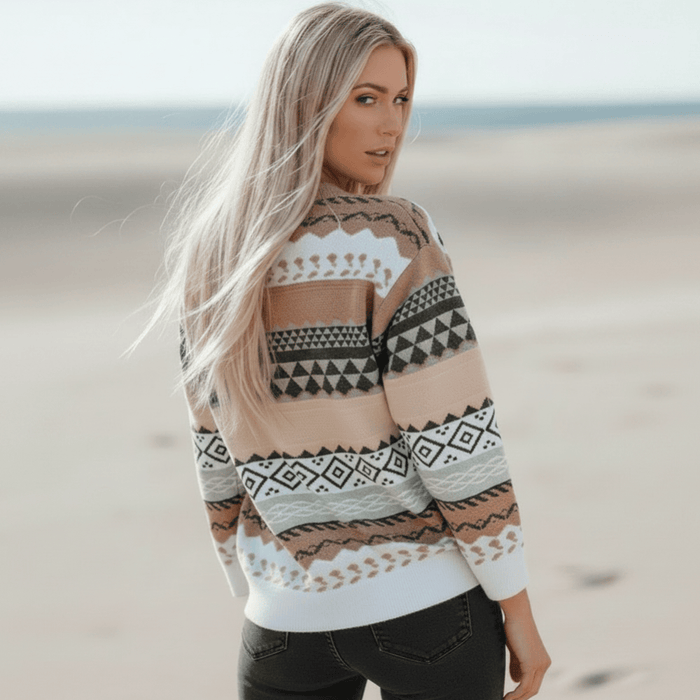 Back of a woman wearing a pink, cream, black and brown boho geometric knit pullover sweater with long sleeves, O-neck and relaxed loose fit