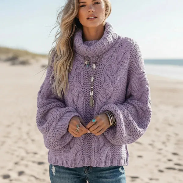 Woman wearing lilac boho chunky knit turtleneck sweater with wide sleeves