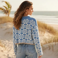 Back of woman wearing cornflower blue floral boho knit pullover sweater with long sleeves