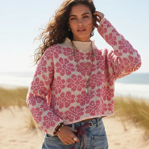 Woman wearing pink floral boho knit pullover sweater with long sleeves
