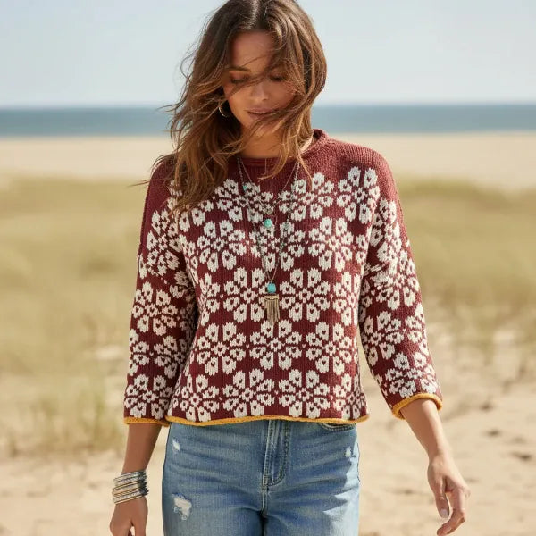 Woman wearing wine red floral boho knit pullover sweater with long sleeves