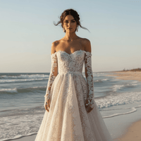 Close up of a bride wearing a white off-the-shoulder floral lace ball gown wedding dress with sweetheart neckline, long illusion sleeves, embroidered lace, and dramatic court train.