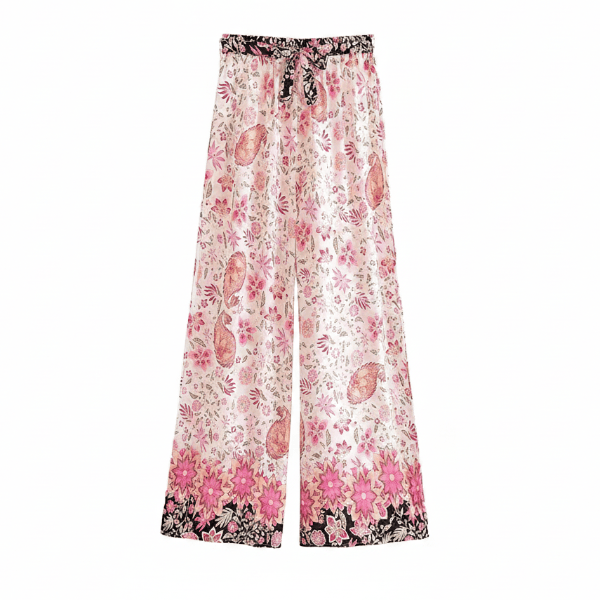 Blush Blossom boho wide leg pants with functional side pockets, a high waist drawstring waistband, lightweight rayon fabric, and a flowy floral palazzo silhouette featuring a pink floral and paisley print.