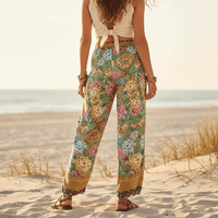 Woman showing the back of her Boho Botanical Paradise wide leg palazzo pants with floral and peacock print in lightweight rayon fabric.