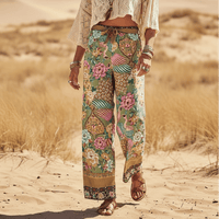 Woman wearing Boho Botanical Paradise wide leg palazzo pants with floral and peacock print in lightweight rayon fabric.