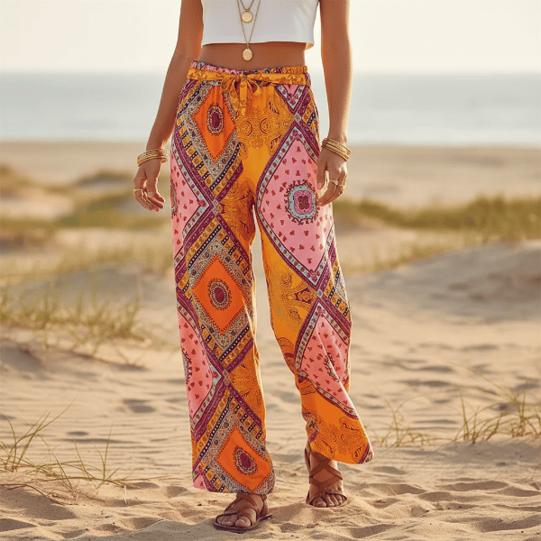 Women’s colorful boho printed wide leg palazzo pants made from lightweight rayon with a patchwork-inspired paisley print and elastic drawstring waistband.
