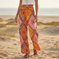 Women’s colorful boho printed wide leg palazzo pants made from lightweight rayon with a patchwork-inspired paisley print and elastic drawstring waistband.