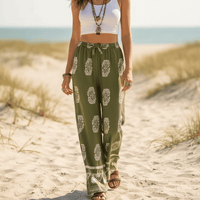 Woman wearing Boho Olive Meadow wide leg palazzo pants in olive green with ivory boho print and relaxed rayon fabric.