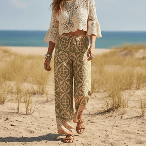 Woman wearing olive sage boho wide leg pants in lightweight rayon with an earthy bohemian print